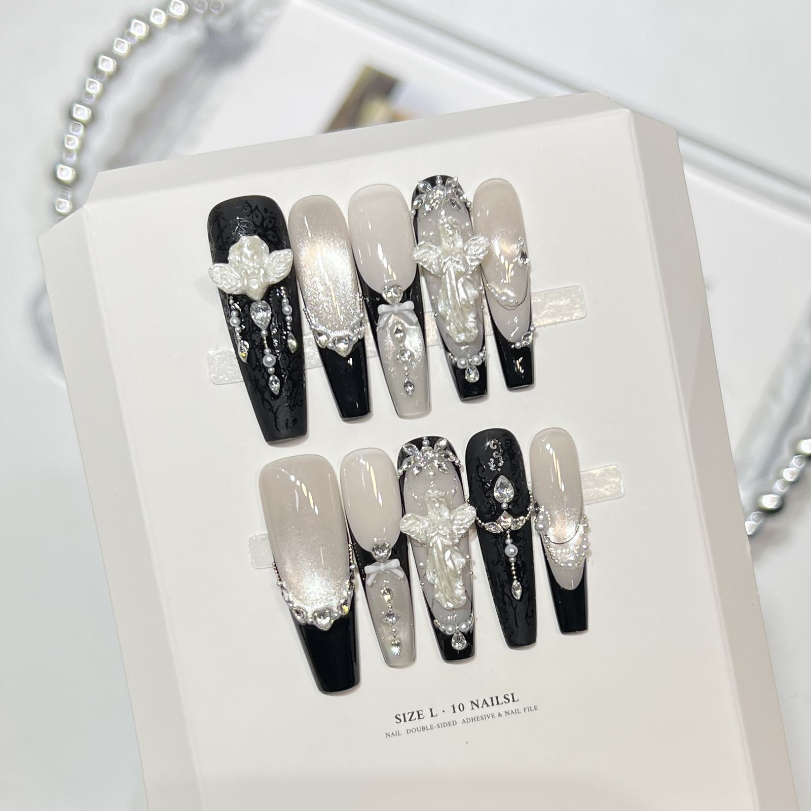 Black and silver 3D press-on nails with floral details and gems